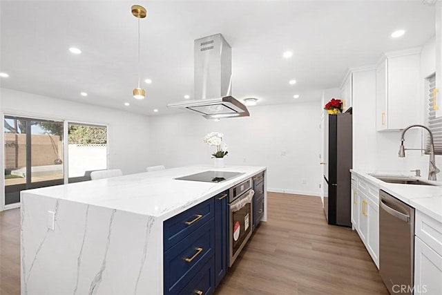 kitchen featuring white cabinetry, stainless steel appliances, a spacious island, blue cabinets, and island exhaust hood