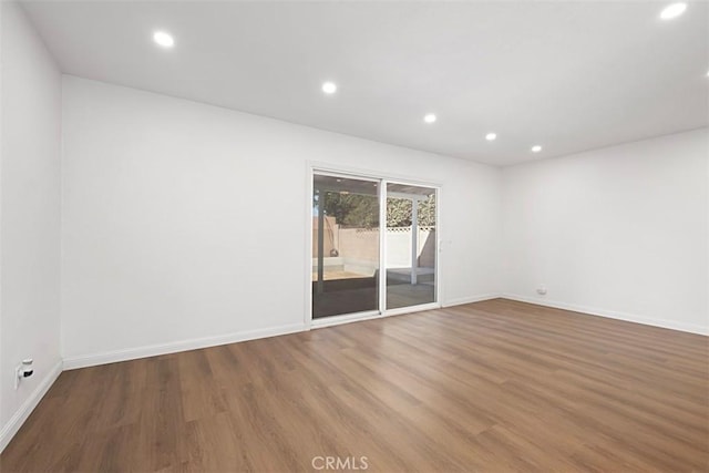 unfurnished room featuring hardwood / wood-style flooring