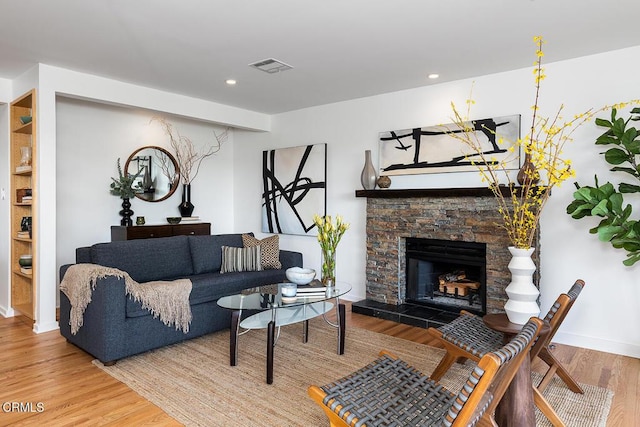 living room with hardwood / wood-style flooring and a fireplace