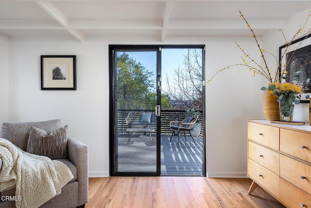 doorway featuring coffered ceiling, beam ceiling, and light hardwood / wood-style floors