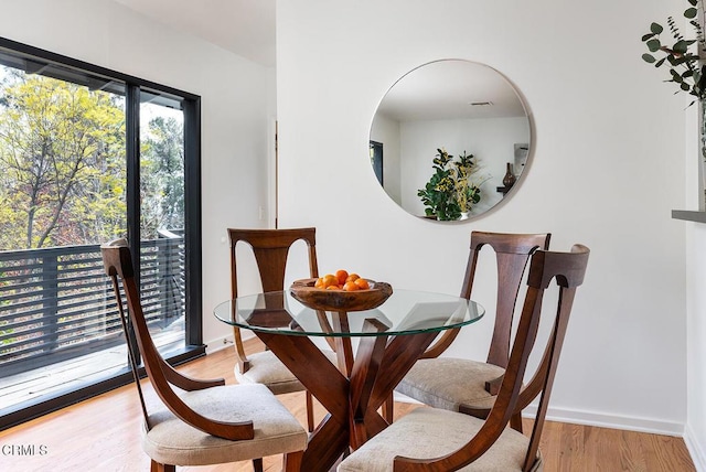 dining space with light wood-type flooring