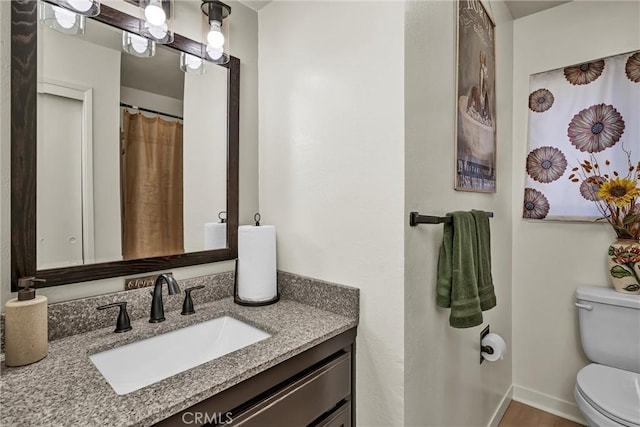 bathroom featuring vanity and toilet