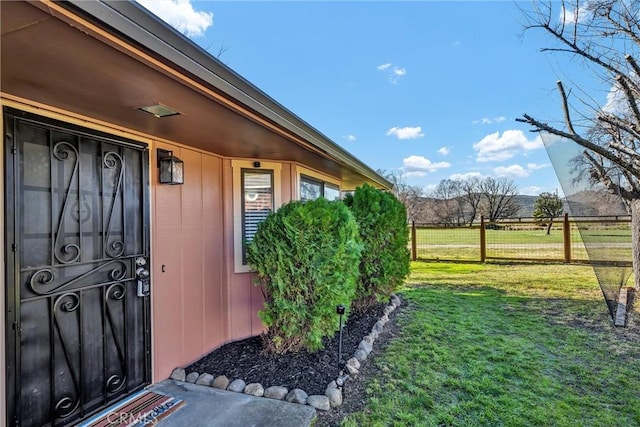 entrance to property featuring a yard