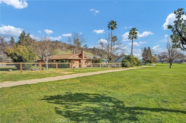 view of property's community featuring a lawn