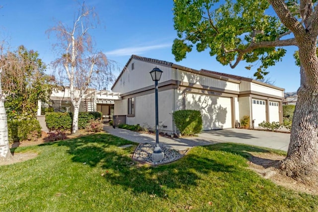 view of front of property featuring a garage and a front lawn