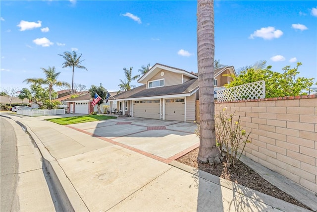 view of front of property with driveway and fence