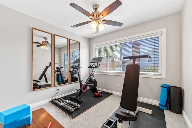 workout room featuring carpet floors, ceiling fan, and baseboards