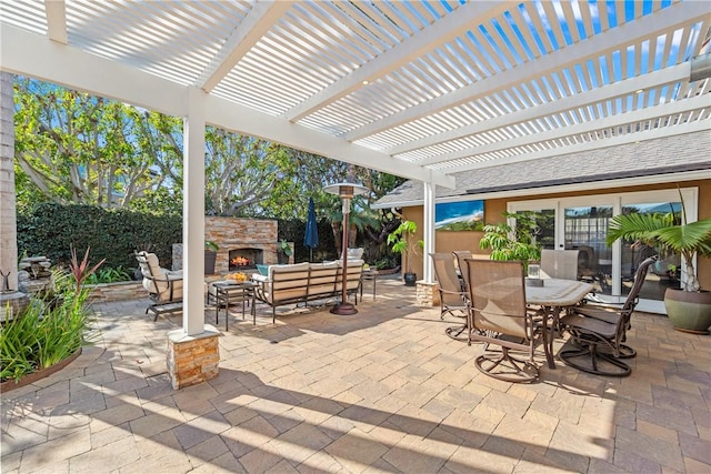 view of patio / terrace with an outdoor living space with a fireplace and outdoor dining area