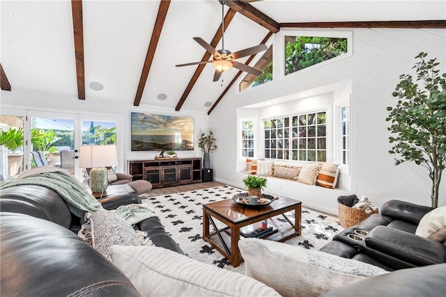 living area with high vaulted ceiling, beam ceiling, and wood finished floors