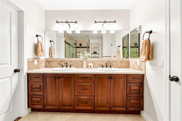 bathroom with double vanity, a stall shower, backsplash, and a sink