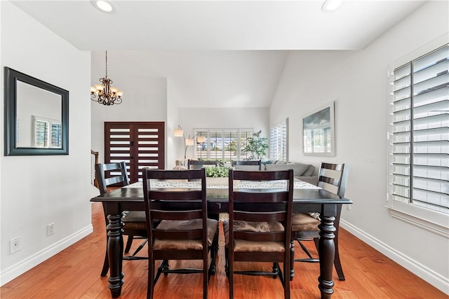 dining area featuring recessed lighting, an inviting chandelier, vaulted ceiling, wood finished floors, and baseboards