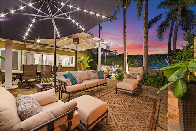 patio terrace at dusk featuring outdoor lounge area