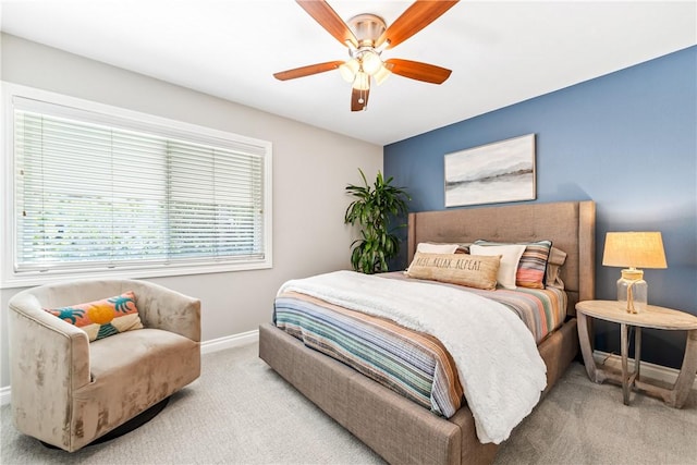 carpeted bedroom featuring a ceiling fan and baseboards