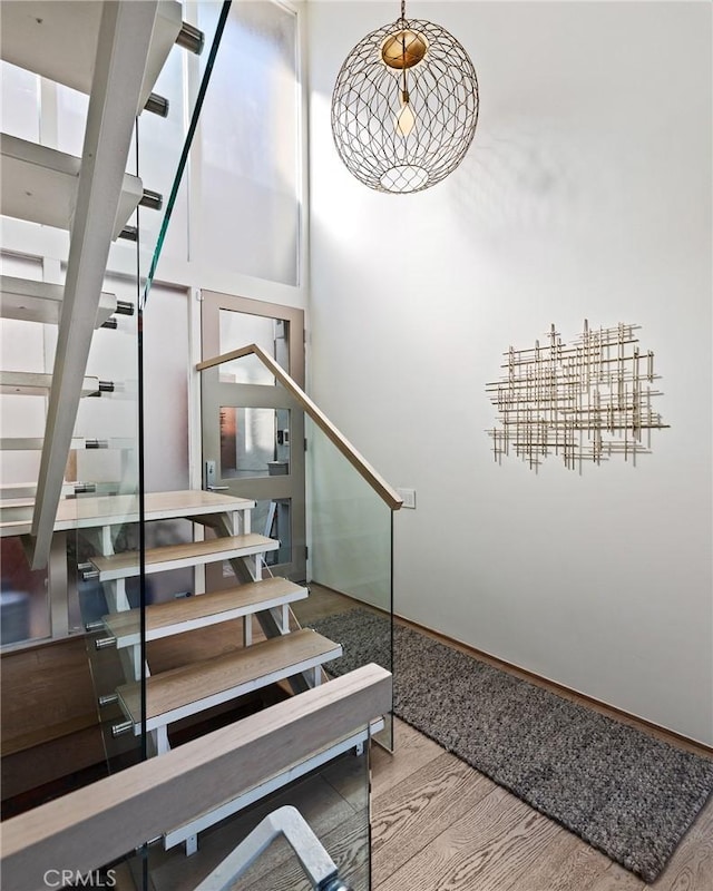 staircase featuring wood-type flooring