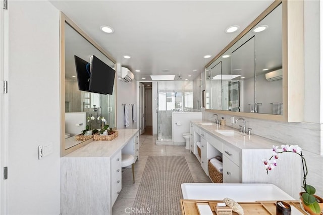 bathroom featuring tile patterned floors, toilet, a wall mounted air conditioner, vanity, and a shower with door