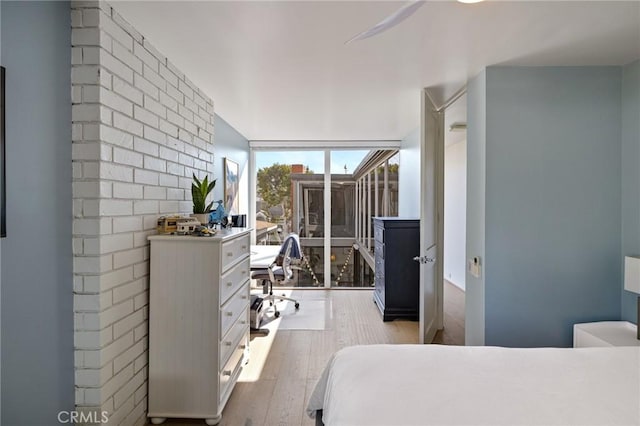 bedroom featuring light hardwood / wood-style flooring and expansive windows