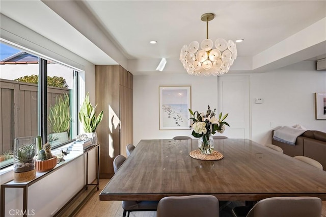 dining area featuring a notable chandelier and light hardwood / wood-style flooring