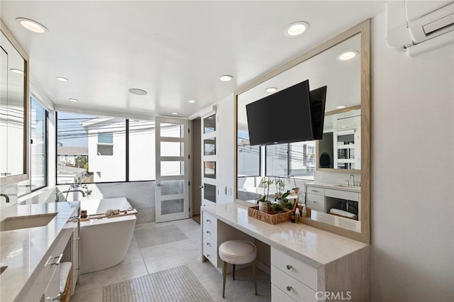 bathroom with vanity, a bath, tile patterned flooring, and a wall unit AC