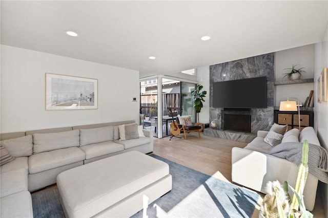 living room featuring hardwood / wood-style flooring and a premium fireplace