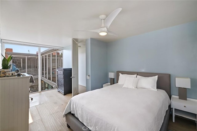 bedroom with hardwood / wood-style flooring and ceiling fan