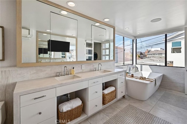 bathroom with vanity, a wall mounted air conditioner, and a washtub