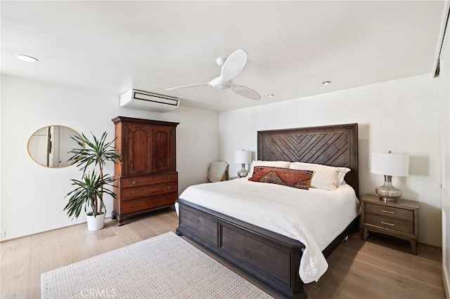 bedroom with ceiling fan and light wood-type flooring