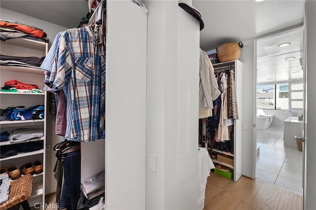 spacious closet with light hardwood / wood-style flooring