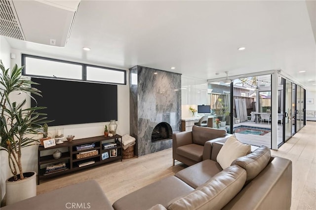 living room featuring light hardwood / wood-style floors and a premium fireplace