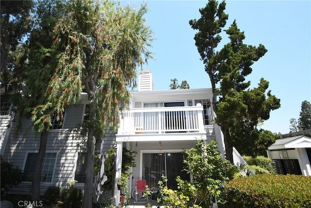 rear view of property with a balcony