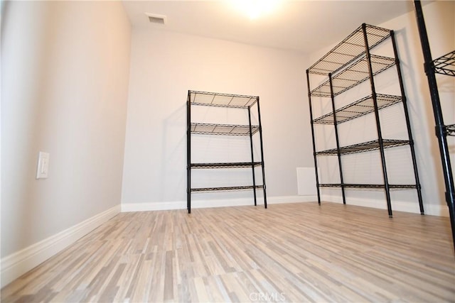 spare room with hardwood / wood-style floors