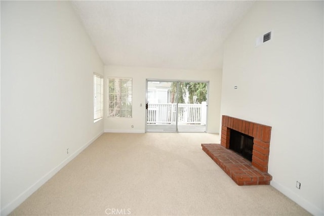 living room featuring a brick fireplace, light carpet, and high vaulted ceiling