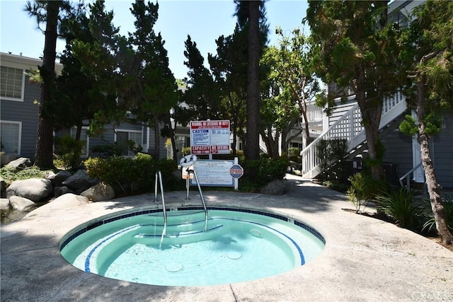 view of pool featuring a hot tub