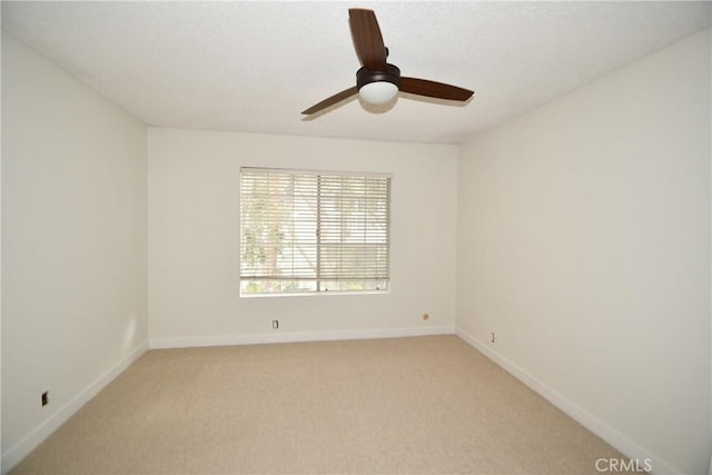 empty room with light colored carpet and ceiling fan