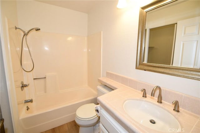 full bathroom featuring shower / washtub combination, toilet, hardwood / wood-style floors, and vanity