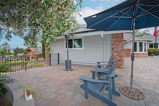 view of patio / terrace featuring fence