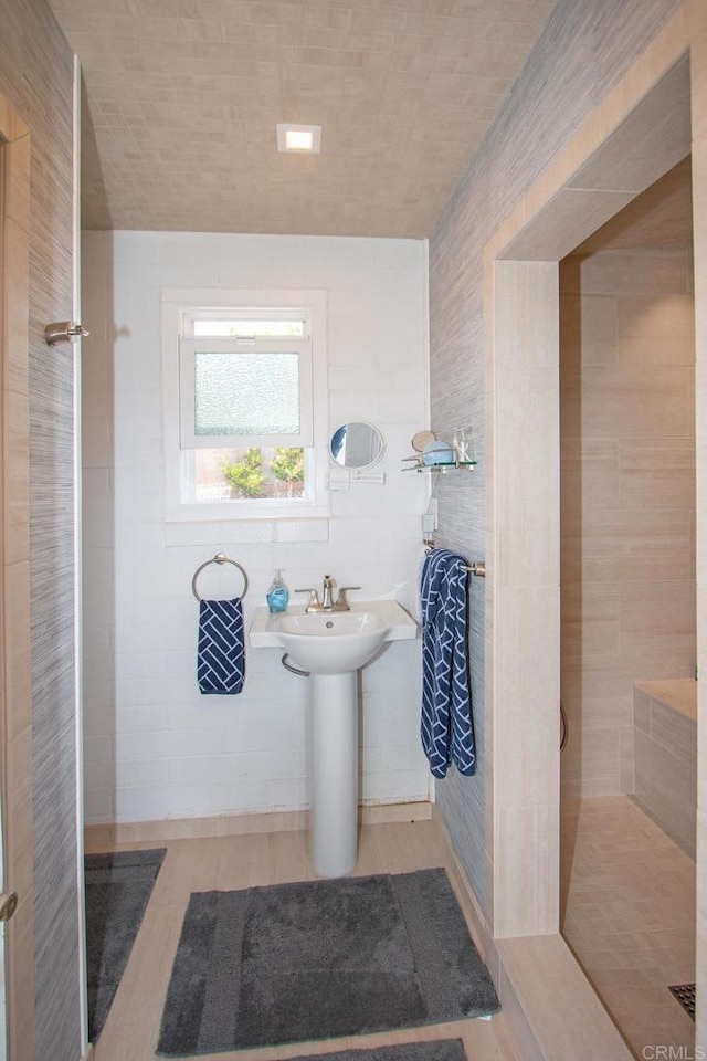 full bath featuring tile walls