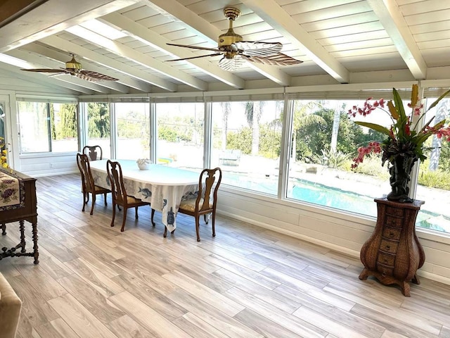 sunroom / solarium featuring vaulted ceiling with beams, a healthy amount of sunlight, and ceiling fan