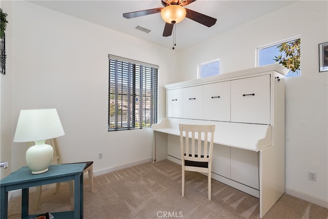 office space with light carpet and ceiling fan