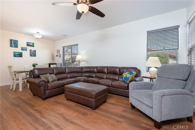 living room featuring ceiling fan and wood-type flooring