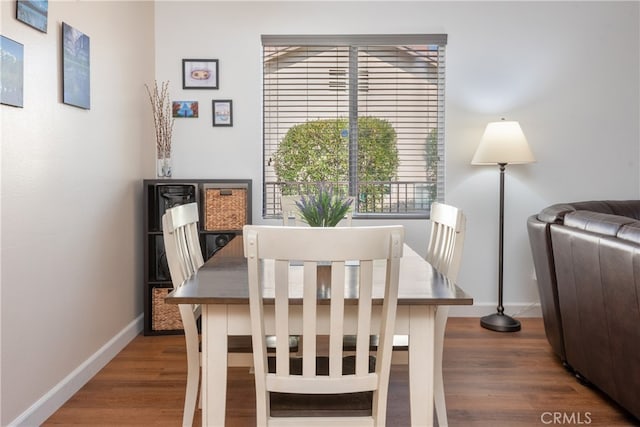 dining space with dark hardwood / wood-style floors