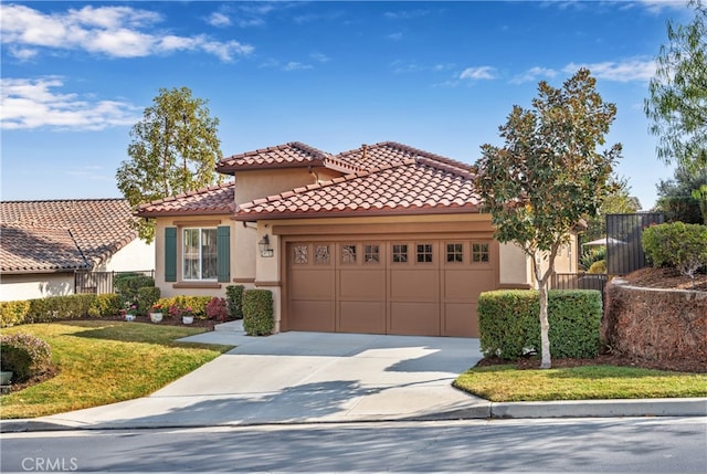 mediterranean / spanish-style home with a garage and a front yard