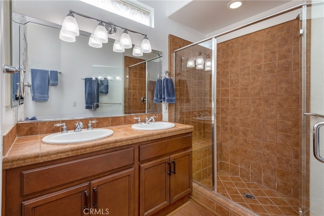 bathroom featuring walk in shower and vanity