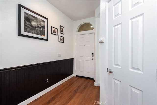 doorway with dark wood-type flooring