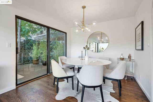 dining area featuring an inviting chandelier and dark hardwood / wood-style floors