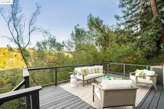 deck featuring an outdoor living space and central AC