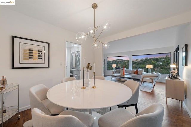 dining space featuring lofted ceiling and dark wood-type flooring