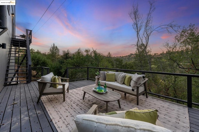 deck at dusk with outdoor lounge area