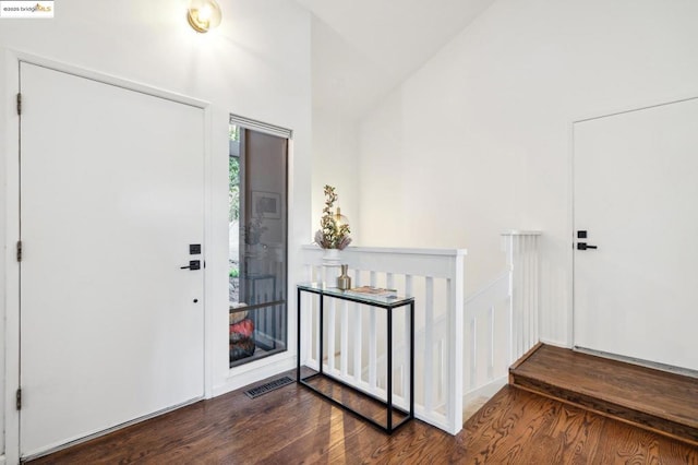 foyer featuring dark hardwood / wood-style floors and high vaulted ceiling