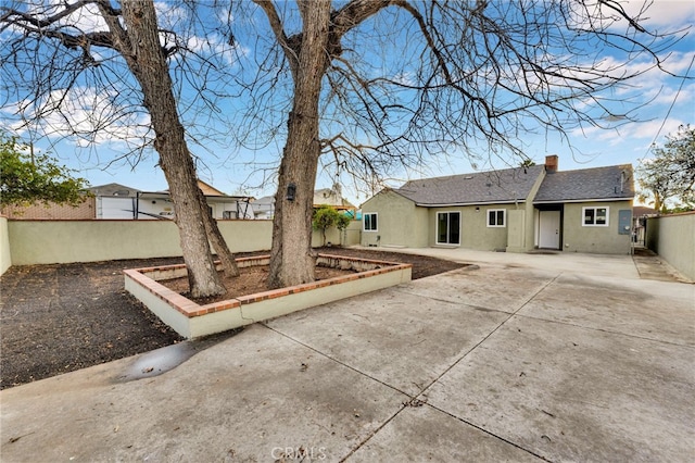 back of property featuring a patio