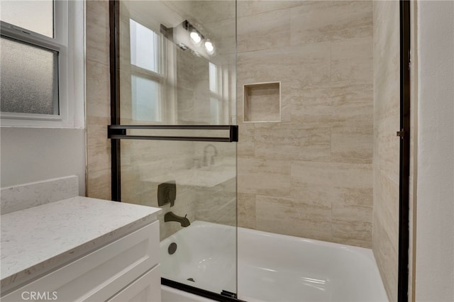 bathroom featuring vanity and enclosed tub / shower combo